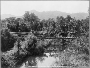 Swamp area in the Rai Valley, Marlborough, with horses hauling a log over a tramway bridge. Photograph taken circa 14 December 1912, by James Raglan Akersten. 