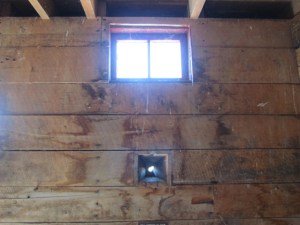 Blockhouse wall, showing high window, and hole for gun barrel. Photo: C.Knight
